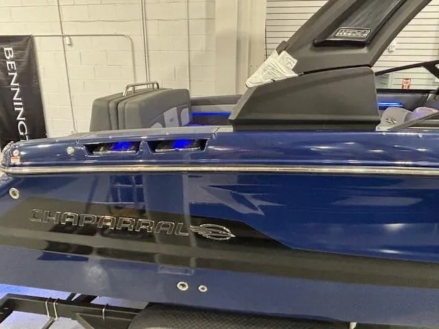 Slide: The Image of 2026 Chaparral SSX 6 boat, blue exterior, sleek design, displayed indoors. - 48