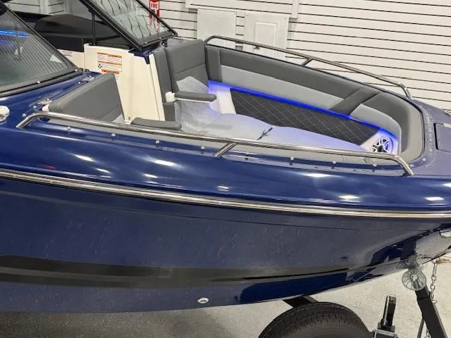 Slide: The Image of 2026 Chaparral SSX 6 boat, blue exterior, sleek design, modern interior lighting. - 50