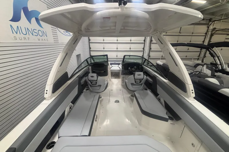 Slide: The Image of 2026 Chaparral 8 SSX boat interior with sleek seating and modern design in showroom. - 14