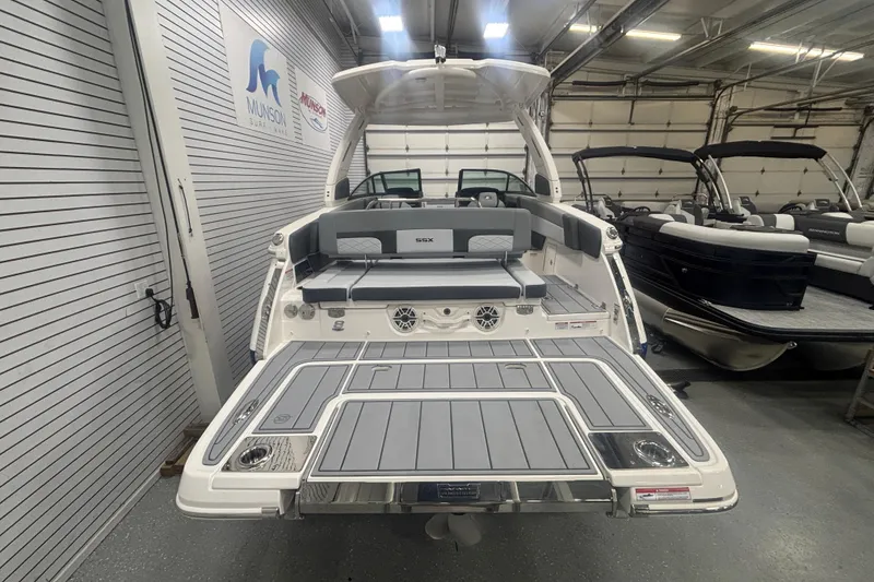 Slide: The Image of 2026 Chaparral 8 SSX boat in showroom, featuring spacious deck and modern design. - 20