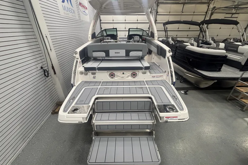 Slide: The Image of 2026 Chaparral 8 SSX boat with spacious deck and seating in showroom. - 37