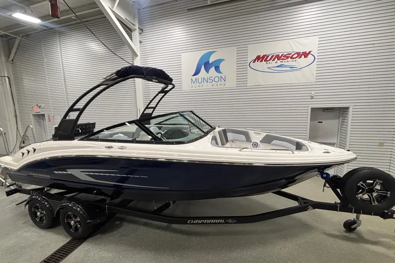 The Image of 2026 Chaparral 23 SSi boat on trailer in showroom setting. - 0