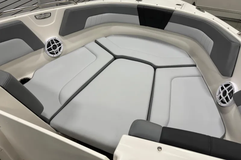 Slide: The Image of 2026 Chaparral 23 SSi boat interior with cushioned seating and built-in speakers. - 11