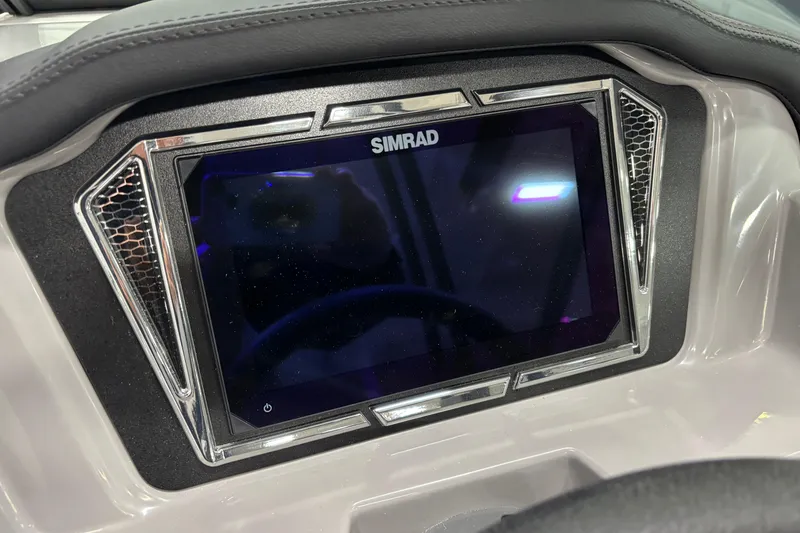 Slide: The Image of Dashboard of 2026 Chaparral 23 SSi featuring a Simrad display screen. - 12