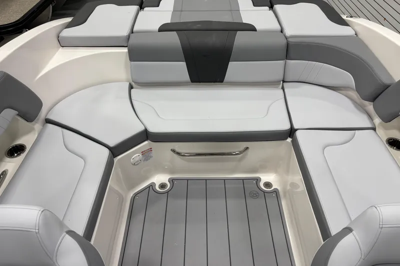 Slide: The Image of 2026 Chaparral 23 SSi boat interior with gray and white cushioned seating. - 19