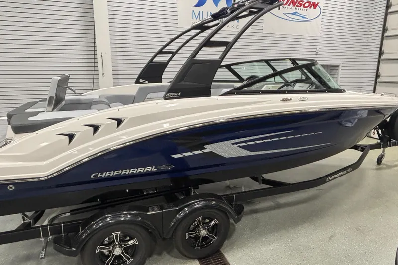 Slide: The Image of 2026 Chaparral 23 SSi boat in showroom, featuring sleek design and modern features. - 4