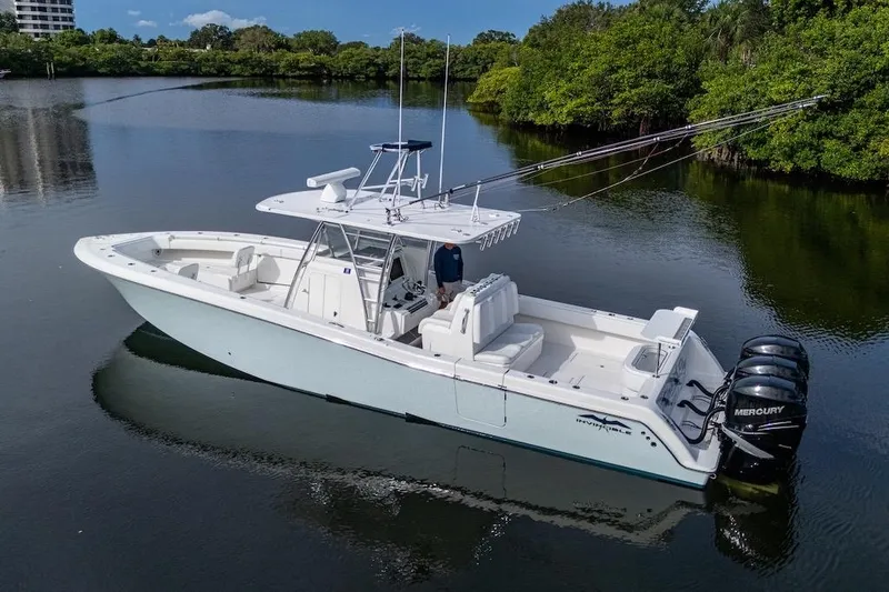 Slide: The Image of 2016 Invincible 39 Open Fisherman boat on calm water with triple Mercury engines. - 1