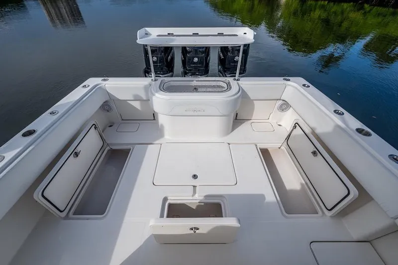 Slide: The Image of 2016 Invincible 39 Open Fisherman boat deck with storage compartments and outboard motors. - 16