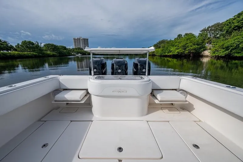 Slide: The Image of 2016 Invincible 39 Open Fisherman boat with spacious deck and dual engines on calm water. - 17