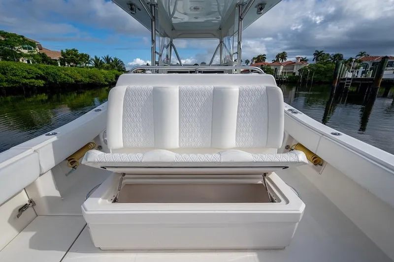 Slide: The Image of 2016 Invincible 39 Open Fisherman boat with open storage under white cushioned seat. - 18
