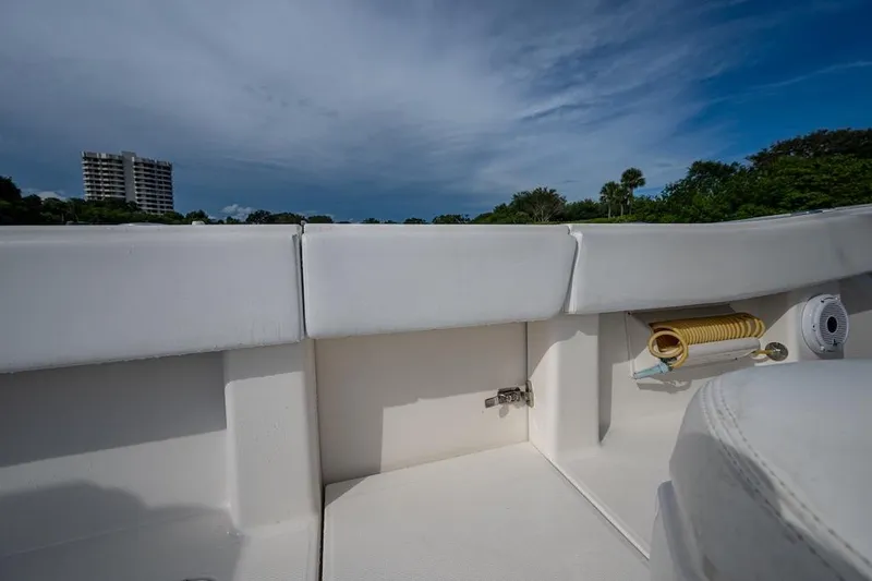 Slide: The Image of 2016 Invincible 39 Open Fisherman boat interior with storage compartment and scenic background. - 19