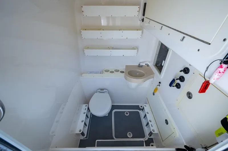 Slide: The Image of Interior of 2016 Invincible 39 Open Fisherman boat bathroom with toilet and sink. - 23