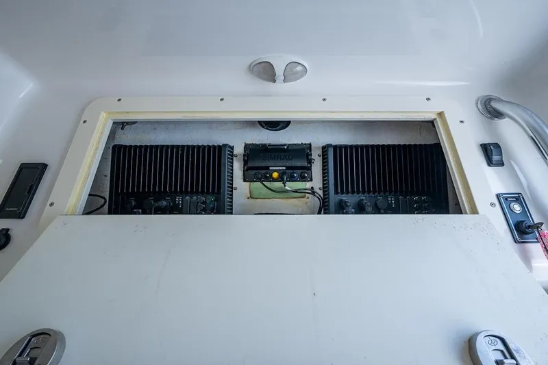 Slide: The Image of Electronics compartment of 2016 Invincible 39 Open Fisherman boat, featuring Simrad equipment. - 24