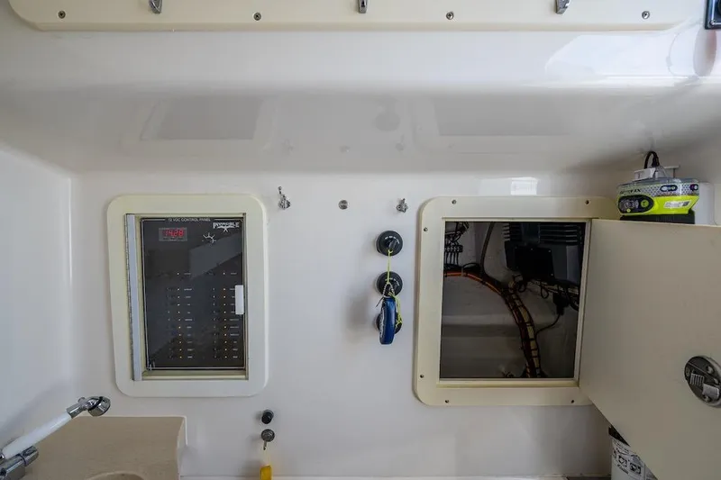 Slide: The Image of Interior view of 2016 Invincible 39 Open Fisherman boat's control panel and storage compartment. - 25