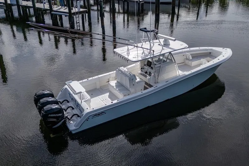 Slide: The Image of 2016 Invincible 39 Open Fisherman boat with triple Mercury engines on calm water. - 3