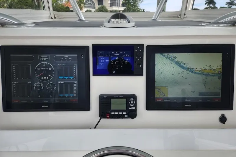 Slide: The Image of Dashboard of a 2016 Invincible 39 Open Fisherman with navigation and control screens. - 36