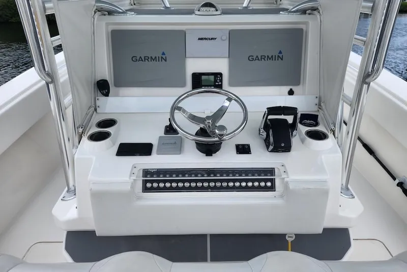 Slide: The Image of 2016 Invincible 39 Open Fisherman boat console with Garmin displays and steering wheel. - 37