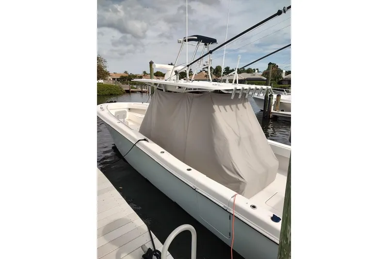 Slide: The Image of 2016 Invincible 39 Open Fisherman boat docked, covered, with fishing rod holders. - 39