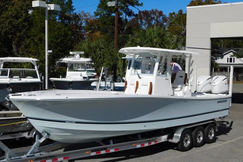 The Image of 2026 Regulator 30XO boat on trailer, displayed outdoors with other boats. - 0