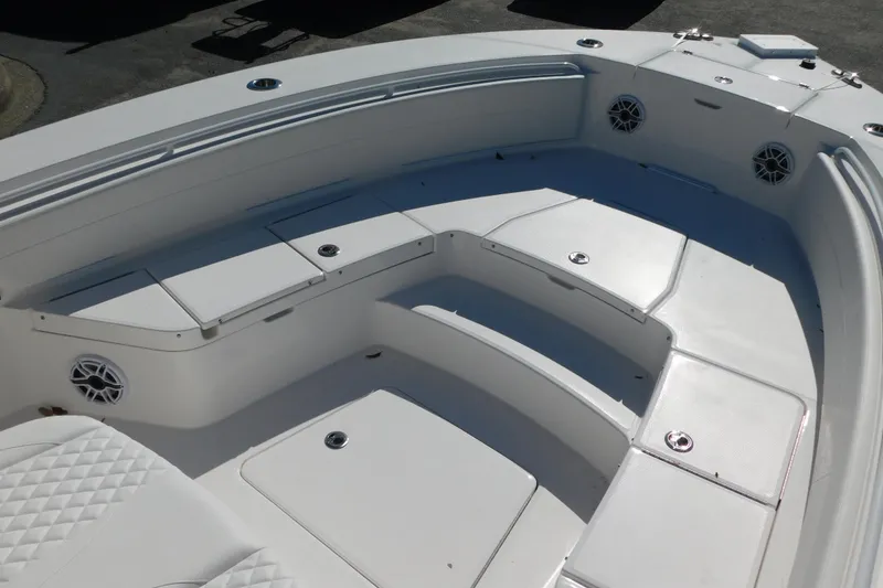 Slide: The Image of 2026 Regulator 30XO boat interior with white seating and storage compartments. - 10