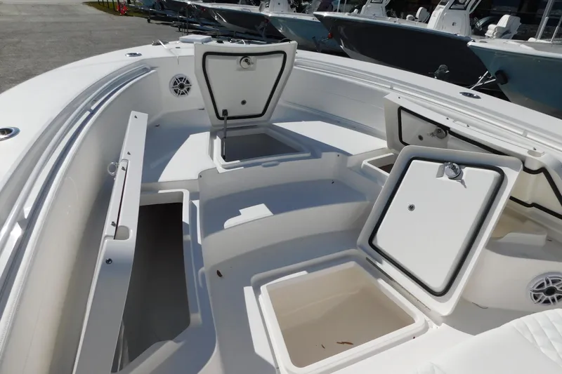 Slide: The Image of 2026 Regulator 30XO boat interior with open storage compartments and seating. - 11