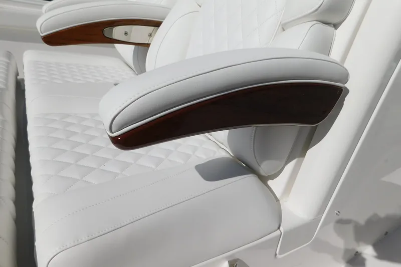 Slide: The Image of Luxurious white seating with wooden armrests on 2026 Regulator 30XO boat. - 17