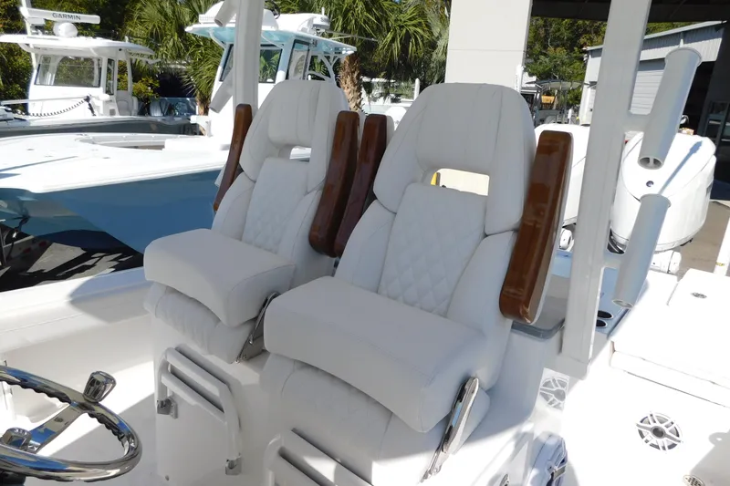 Slide: The Image of 2026 Regulator 30XO boat with luxurious white seating and wooden armrests. - 18