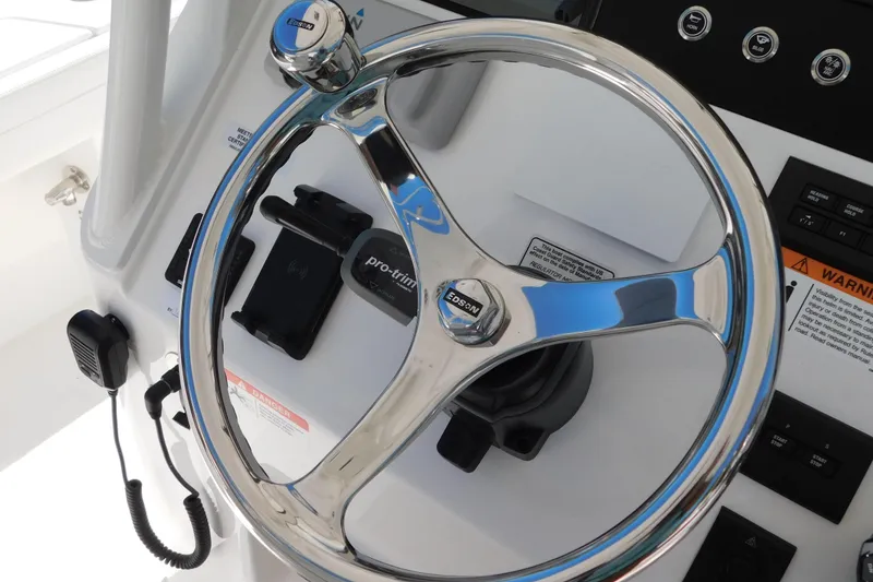 Slide: The Image of Steering wheel of 2026 Regulator 30XO boat with control panel and microphone. - 2