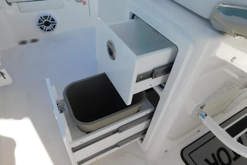 Slide: The Image of 2026 Regulator 30XO boat storage compartment with open drawers and bin. - 22