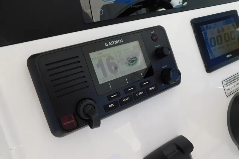 Slide: The Image of Garmin marine radio on 2026 Regulator 30XO boat dashboard, displaying channel 16. - 24