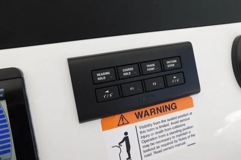 Slide: The Image of Control panel on 2026 Regulator 30XO boat with navigation buttons and warning label. - 26