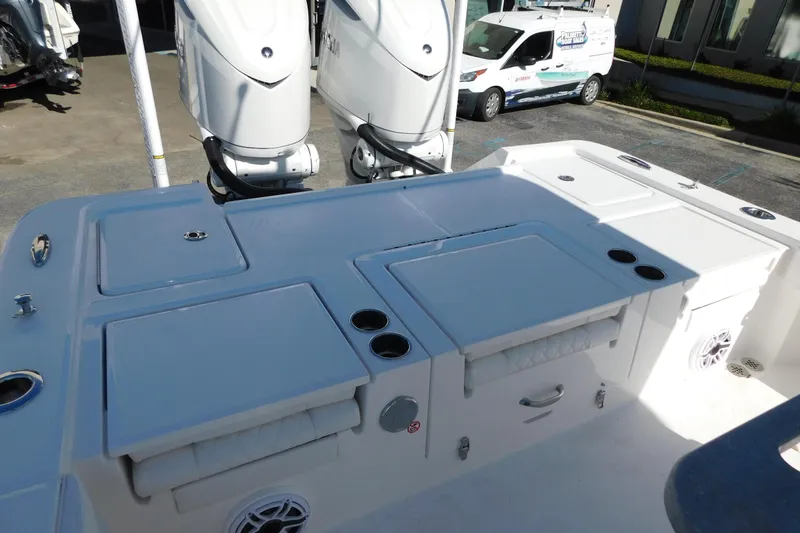 Slide: The Image of 2026 Regulator 30XO boat deck with dual outboard motors and storage compartments. - 29