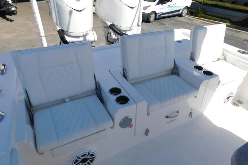 Slide: The Image of 2026 Regulator 30XO boat seating with cup holders and storage compartments. - 30
