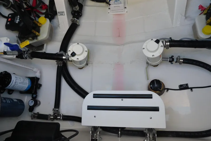 Slide: The Image of 2026 Regulator 30XO boat engine compartment with hoses, filters, and mechanical components. - 35