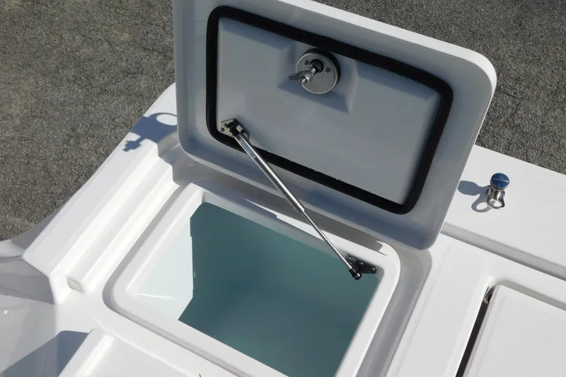 Slide: The Image of Open storage compartment on 2026 Regulator 30XO boat, featuring hydraulic lift support. - 36