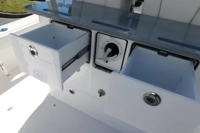 Slide: The Image of 2026 Regulator 30XO boat storage compartments with open drawers and sleek design. - 38