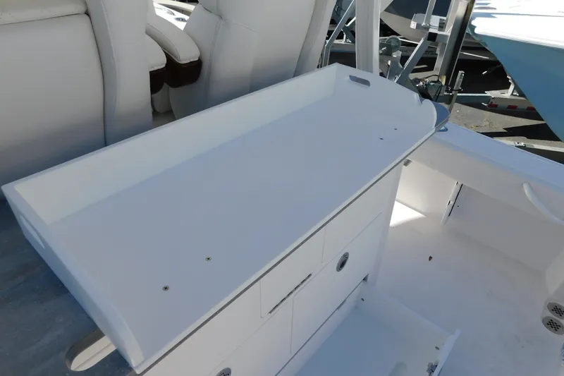 Slide: The Image of 2026 Regulator 30XO boat interior with white seating and storage compartments. - 41