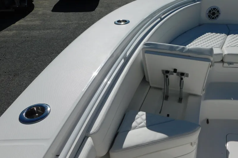 Slide: The Image of 2026 Regulator 30XO boat interior with white seating and stainless steel cup holders. - 47