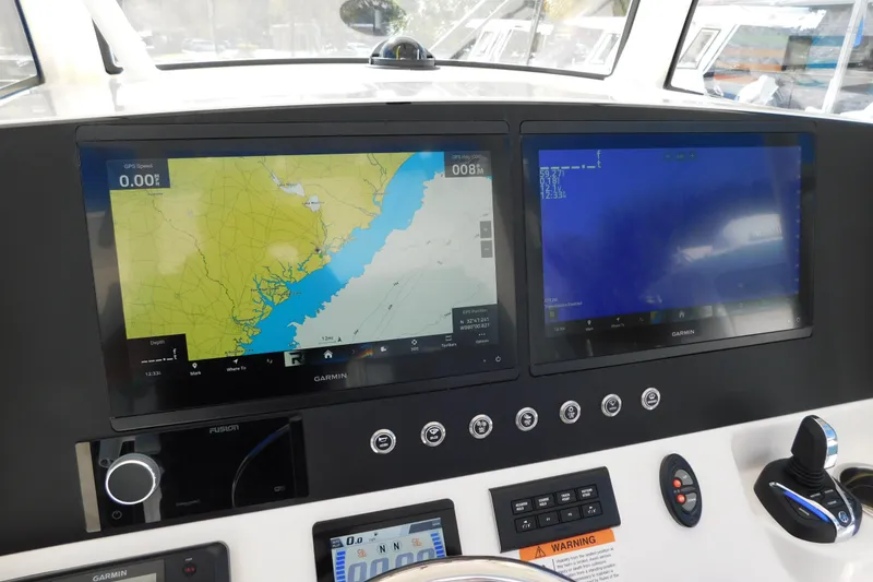 Slide: The Image of 2026 Regulator 30XO boat dashboard with dual Garmin navigation screens. - 5
