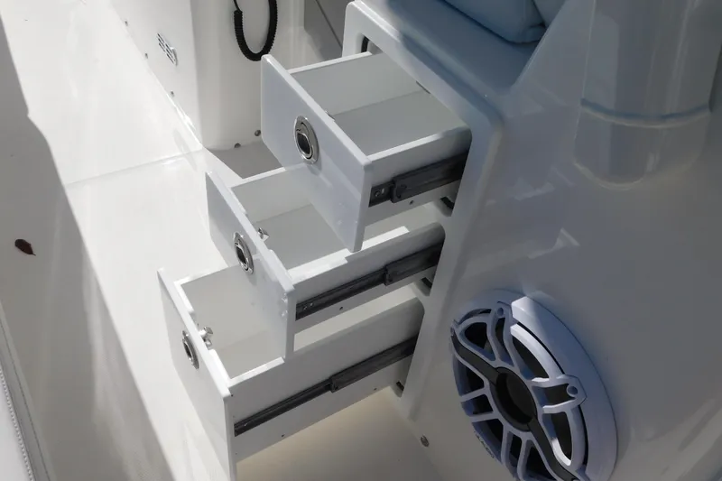 Slide: The Image of 2026 Regulator 30XO boat interior with open storage drawers and speaker. - 50