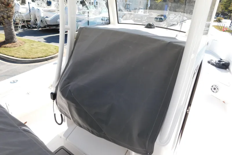 Slide: The Image of 2026 Regulator 30XO boat with covered console, docked outdoors. - 57