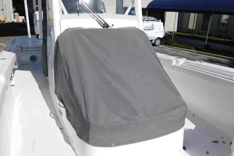 Slide: The Image of 2026 Regulator 30XO boat with covered console, docked outdoors. - 59
