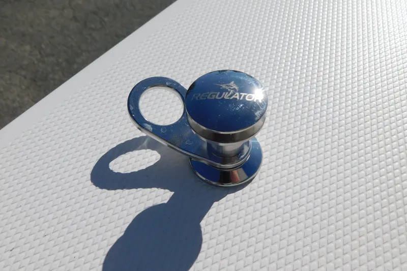 Slide: The Image of Chrome cleat on Regulator 30XO 2026 boat deck, reflecting sunlight. - 60