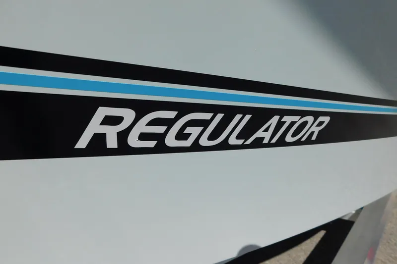 Slide: The Image of Regulator 30XO 2026 boat logo with blue stripe detail. - 65