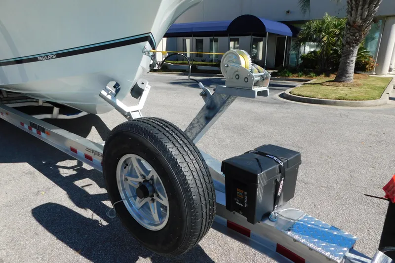 Slide: The Image of 2026 Regulator 30XO boat trailer with winch and spare tire in parking lot. - 66