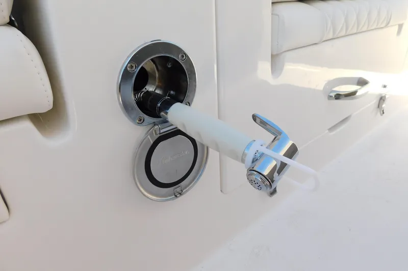 Slide: The Image of 2026 Regulator 30XO boat detail showing a chrome water outlet and hose connection. - 67