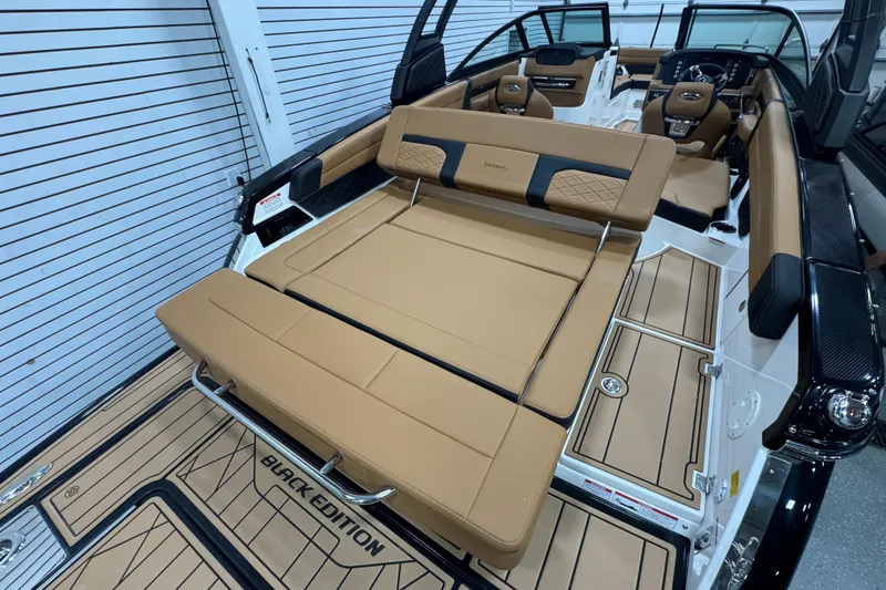 Slide: The Image of 2026 Chaparral 6 SSX boat interior with tan leather seating and "Black Edition" flooring. - 10