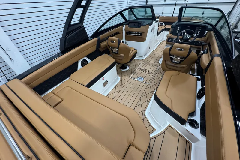 Slide: The Image of 2026 Chaparral 6 SSX boat interior with luxurious tan seating and modern dashboard design. - 11