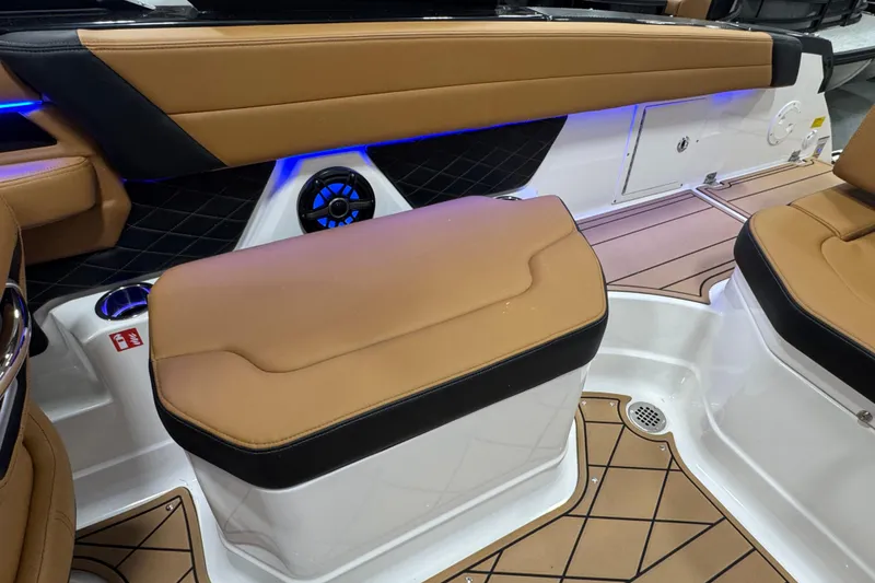 Slide: The Image of 2026 Chaparral 6 SSX boat interior with tan seating, blue LED lighting, and modern design. - 14