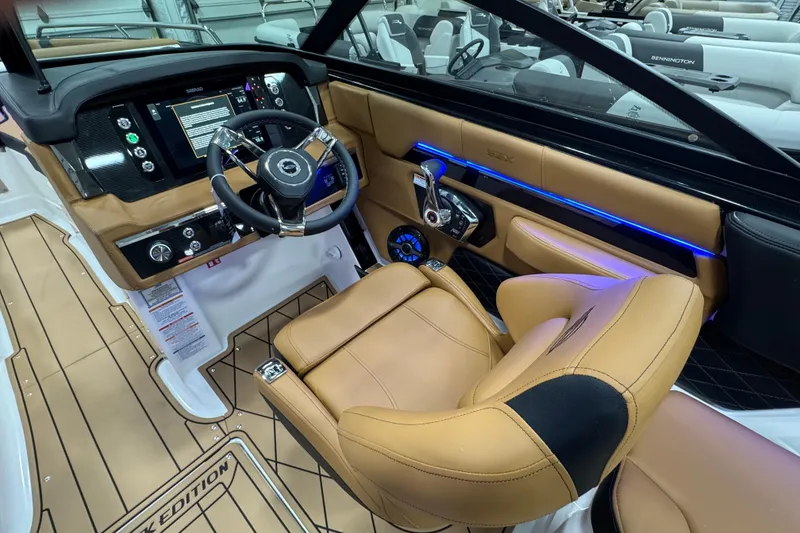 Slide: The Image of 2026 Chaparral 6 SSX boat interior with tan leather seating and modern dashboard controls. - 20